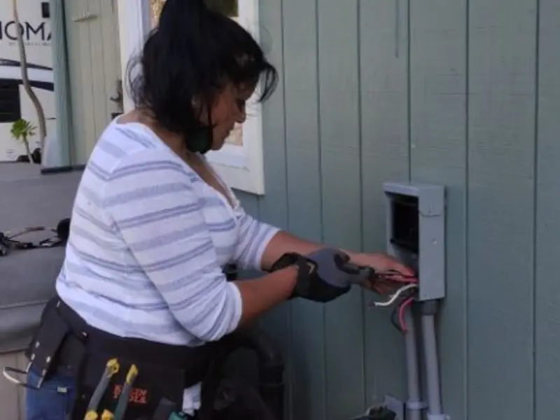 Licensed electrician wiring an exterior subpanel in Aransas Pass